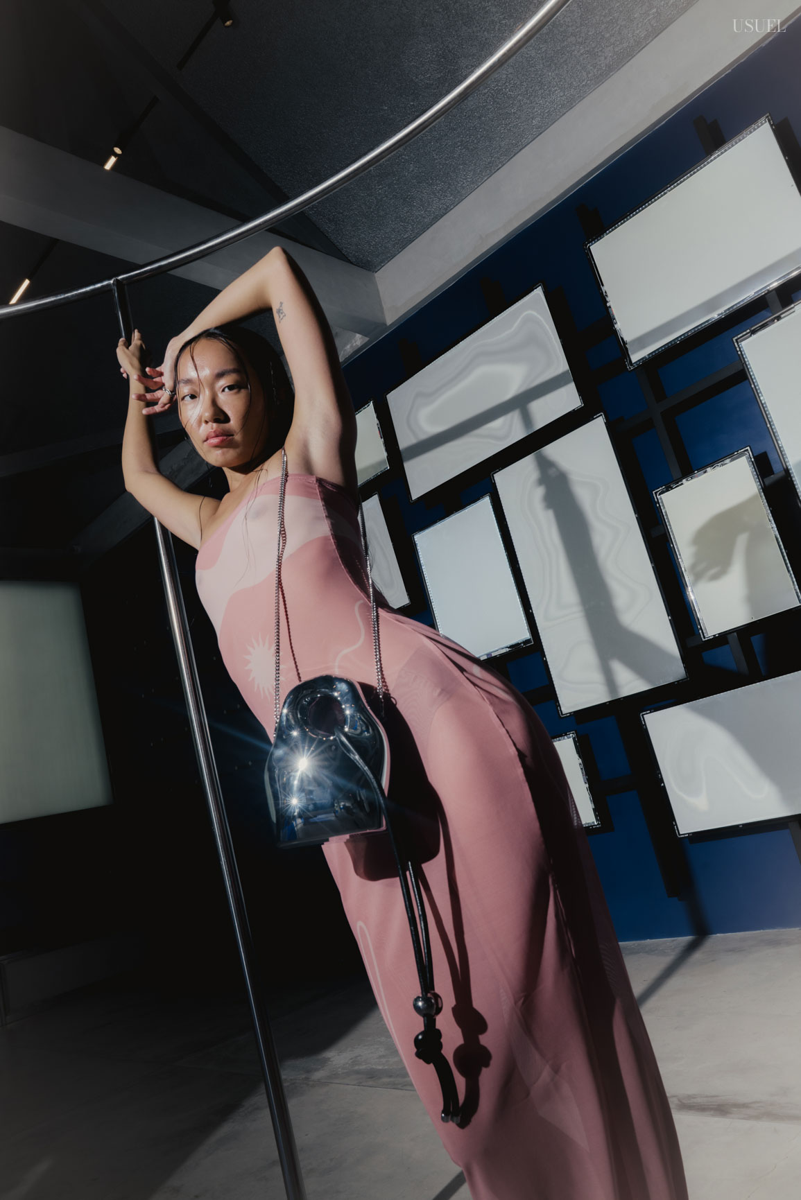 Model Michelle Putri in a sheer Di Petsa dress, posing amidst geometric frames and mirrors