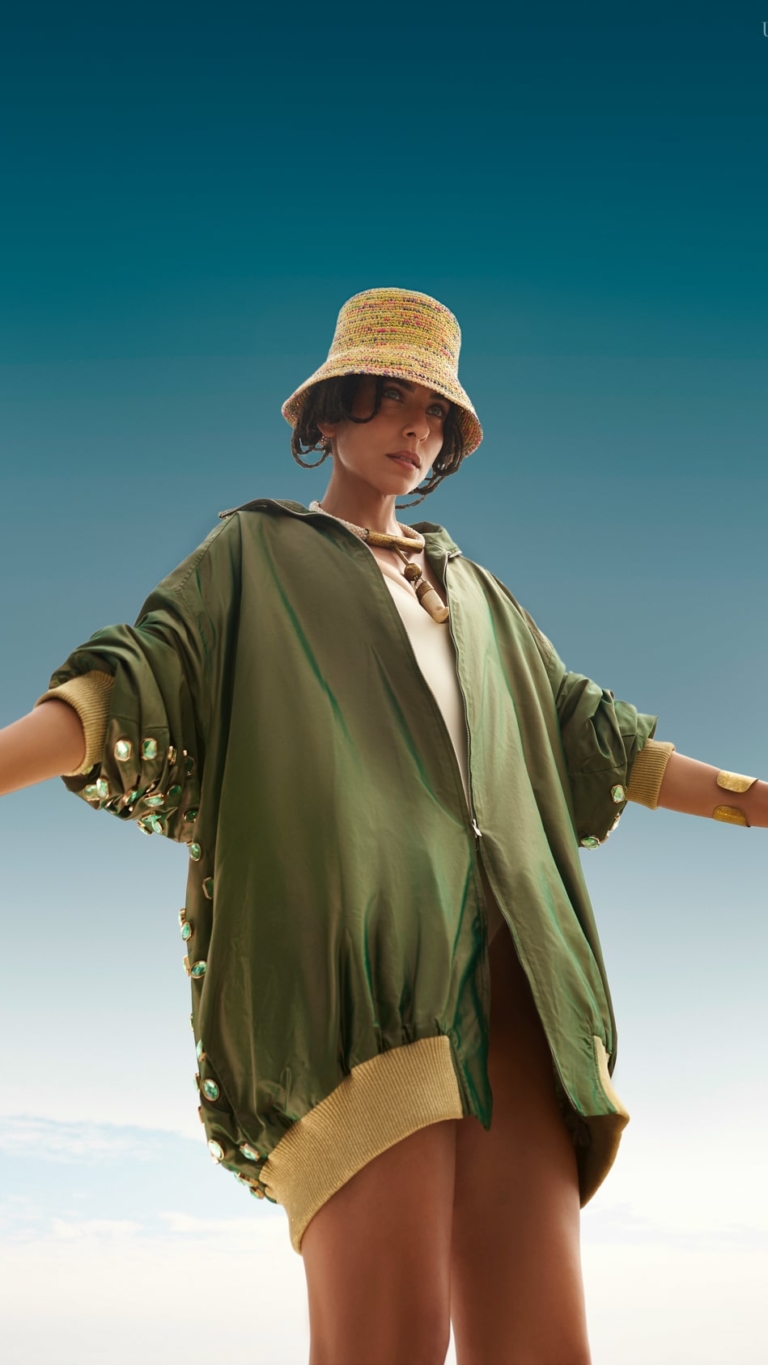 Fashion photoshoot with a woman posing in Ballenita, Ecuador, under a blue sky.