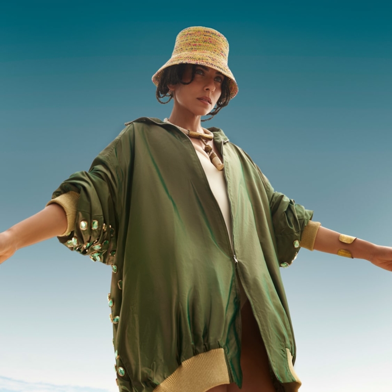 Fashion photoshoot with a woman posing in Ballenita, Ecuador, under a blue sky.