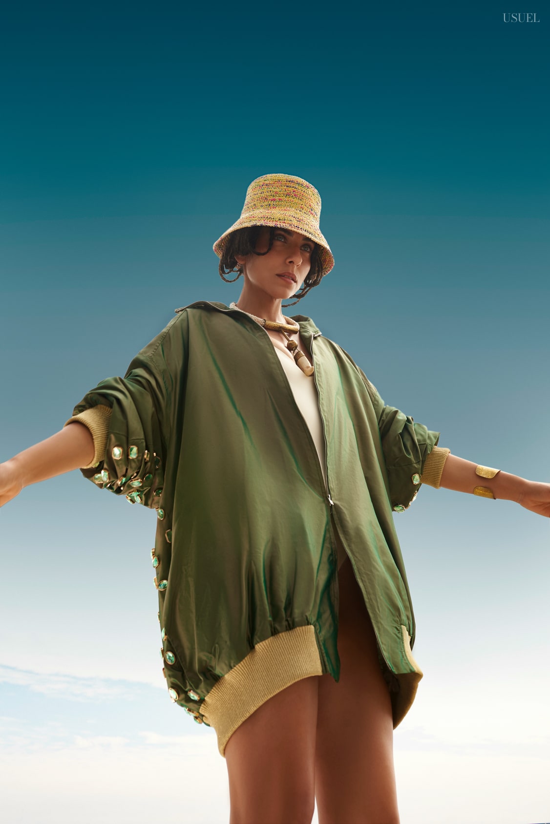 Fashion photoshoot with a woman posing in Ballenita, Ecuador, under a blue sky.