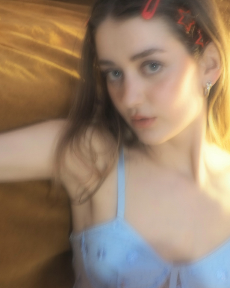 Woman in light blue lingerie lying on a wooden floor