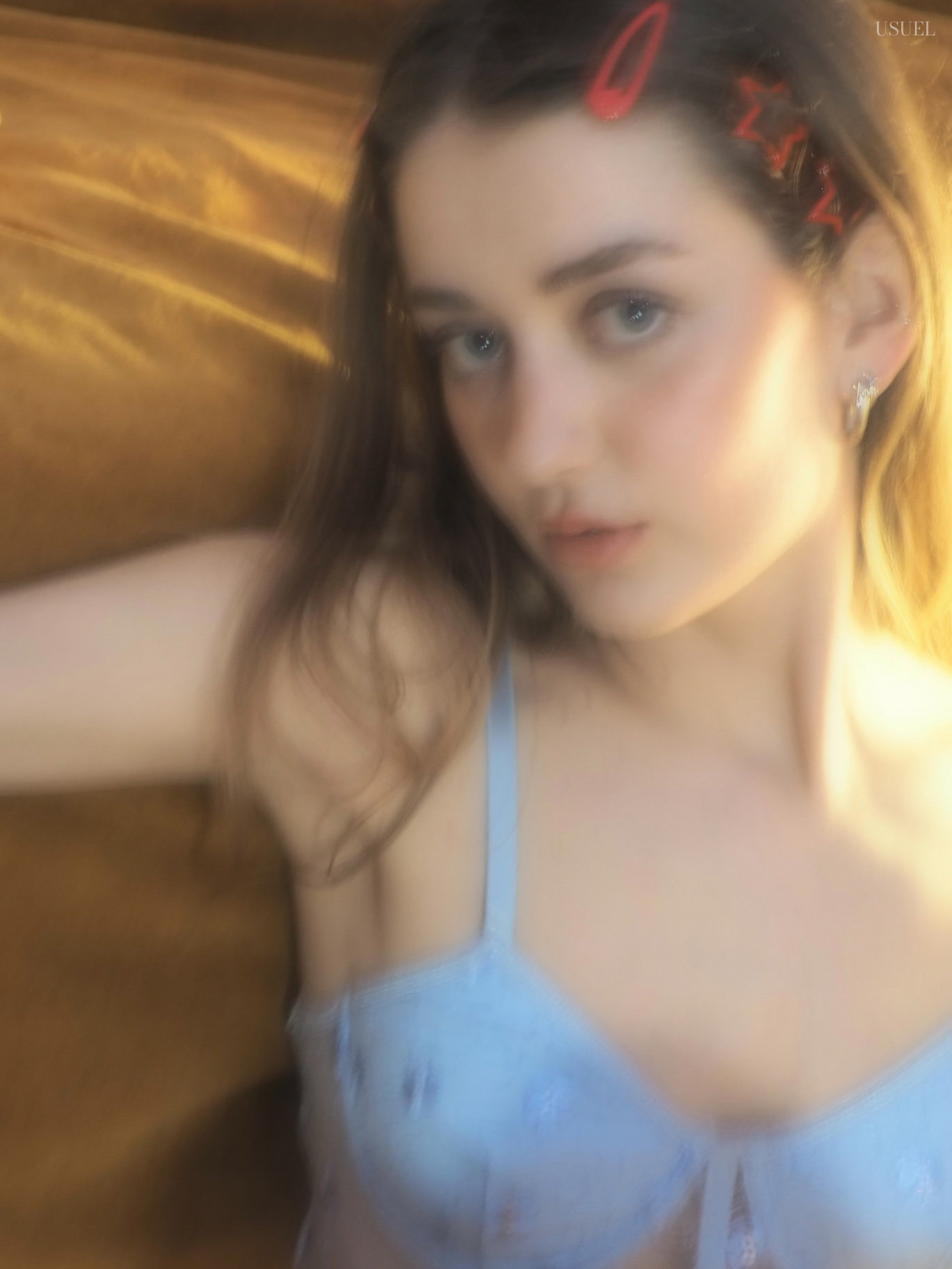 Woman in light blue lingerie lying on a wooden floor